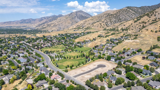 1473 Red Fox Court, Unit 4 Logan, UT 84321 - Photo 5 of 19 Expansive aerial perspective showcasing a developed residential area with numerous single-family homes, mature trees, and a central green space