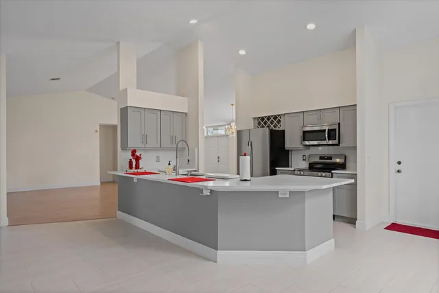 a kitchen with stainless steel appliances a sink and a refrigerator