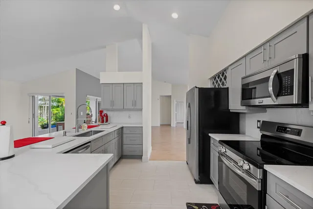 a kitchen with stainless steel appliances a microwave a sink and a refrigerator