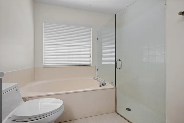 a white bath tub sitting next to a toilet