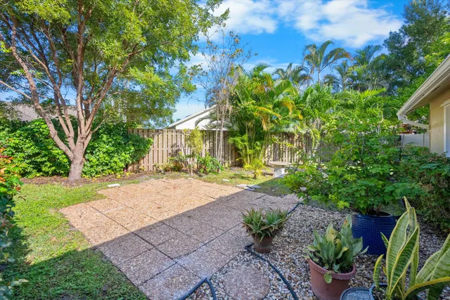 a front view of a house with a yard and a garden