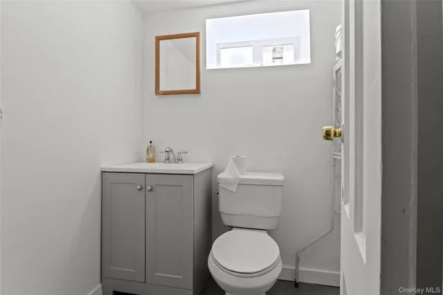 a bathroom with a toilet a sink and mirror