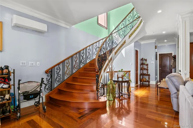 a view of entryway and hall with wooden floor
