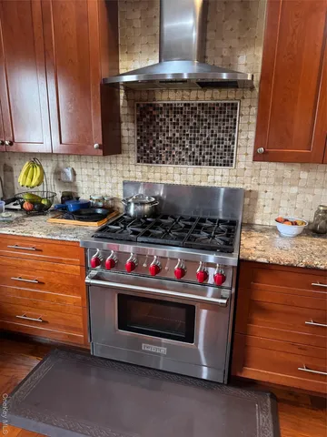 a kitchen with stainless steel appliances granite countertop a stove and a microwave