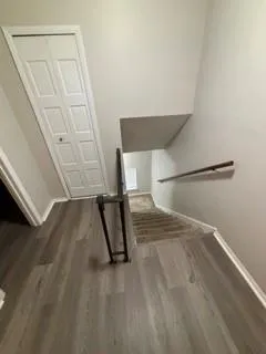 a view of a room with wooden floor