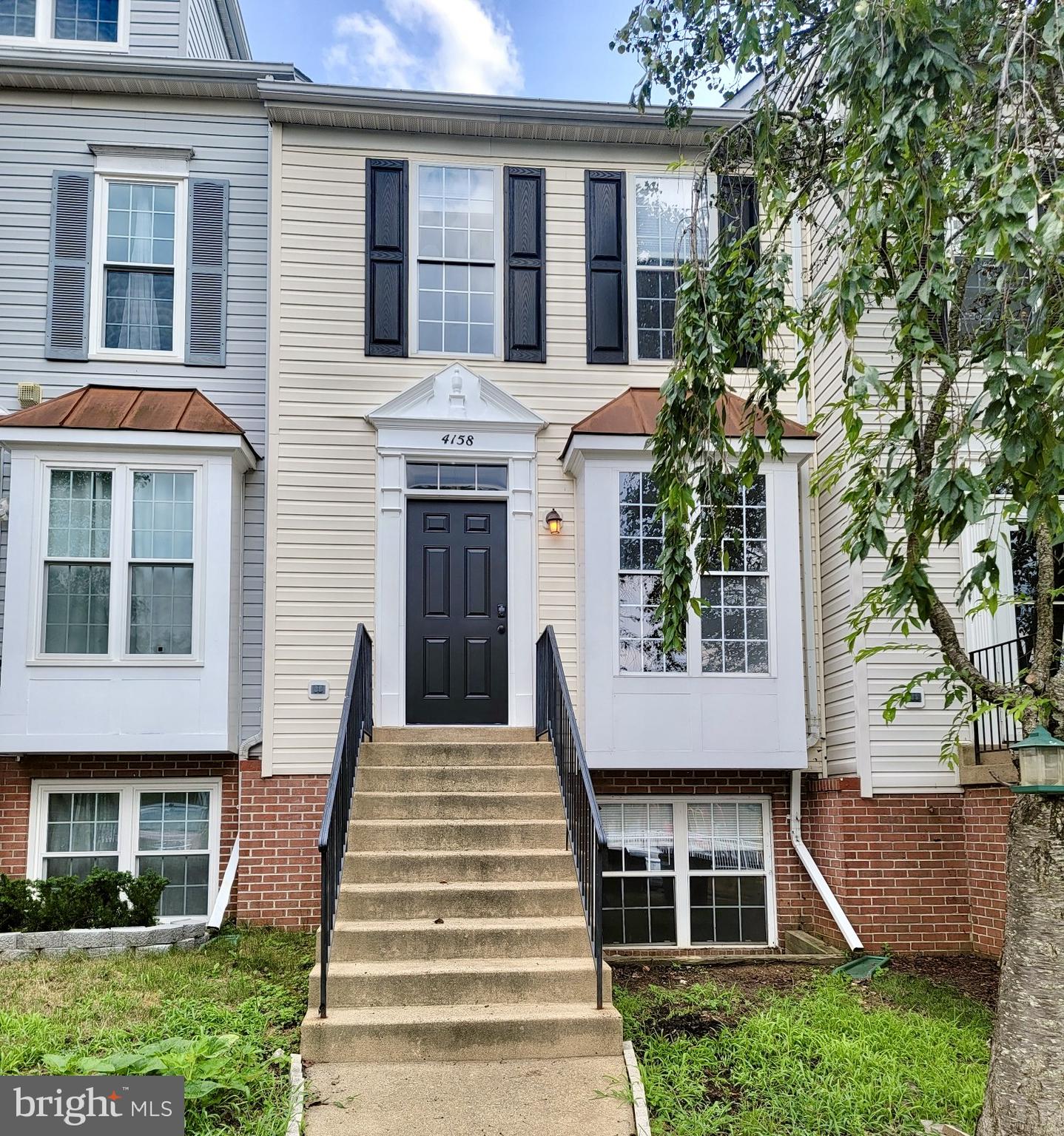 4158 Ashmere Circle Dumfries, VA 22025 - Photo 1 of 28 a front view of a house with a yard and potted plants