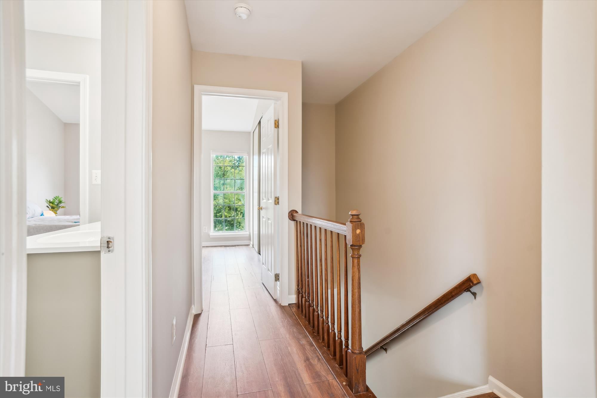 4158 Ashmere Circle Dumfries, VA 22025 - Photo 12 of 28 a view of a hallway with wooden floor and a bathroom
