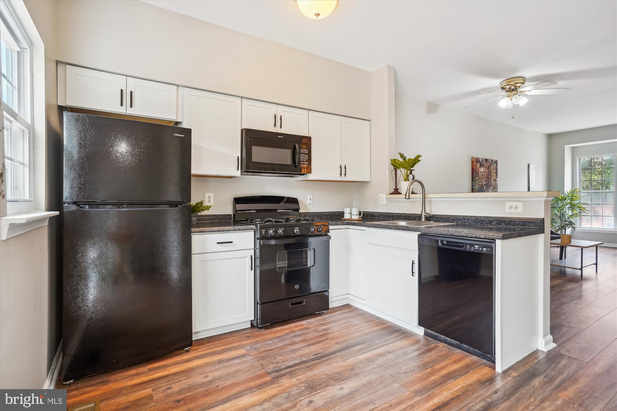 4158 Ashmere Circle Dumfries, VA 22025 - Photo 7 of 28 a kitchen with a refrigerator and a stove top oven