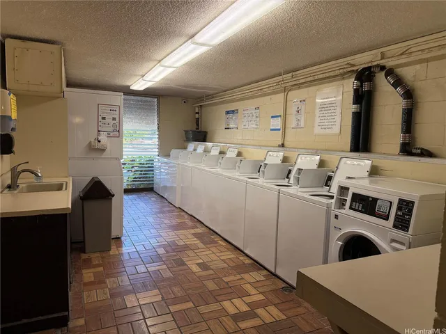 a utility room with cabinets a washer and dryer