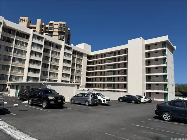 a couple of cars parked in front of a building
