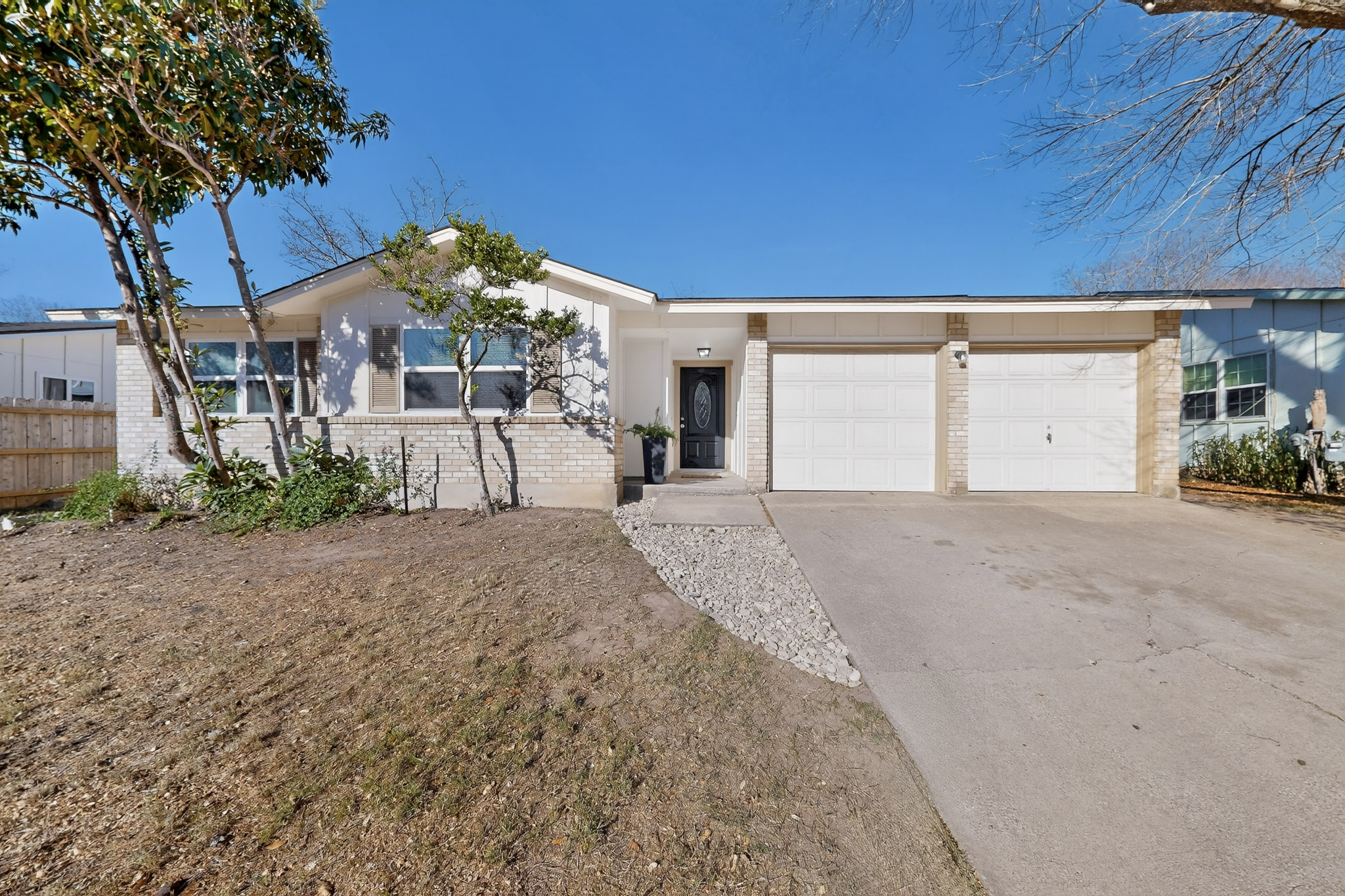 7200 Barnsdale Way Austin, TX 78745 - Photo 1 of 26 a view of a house with a yard and garage