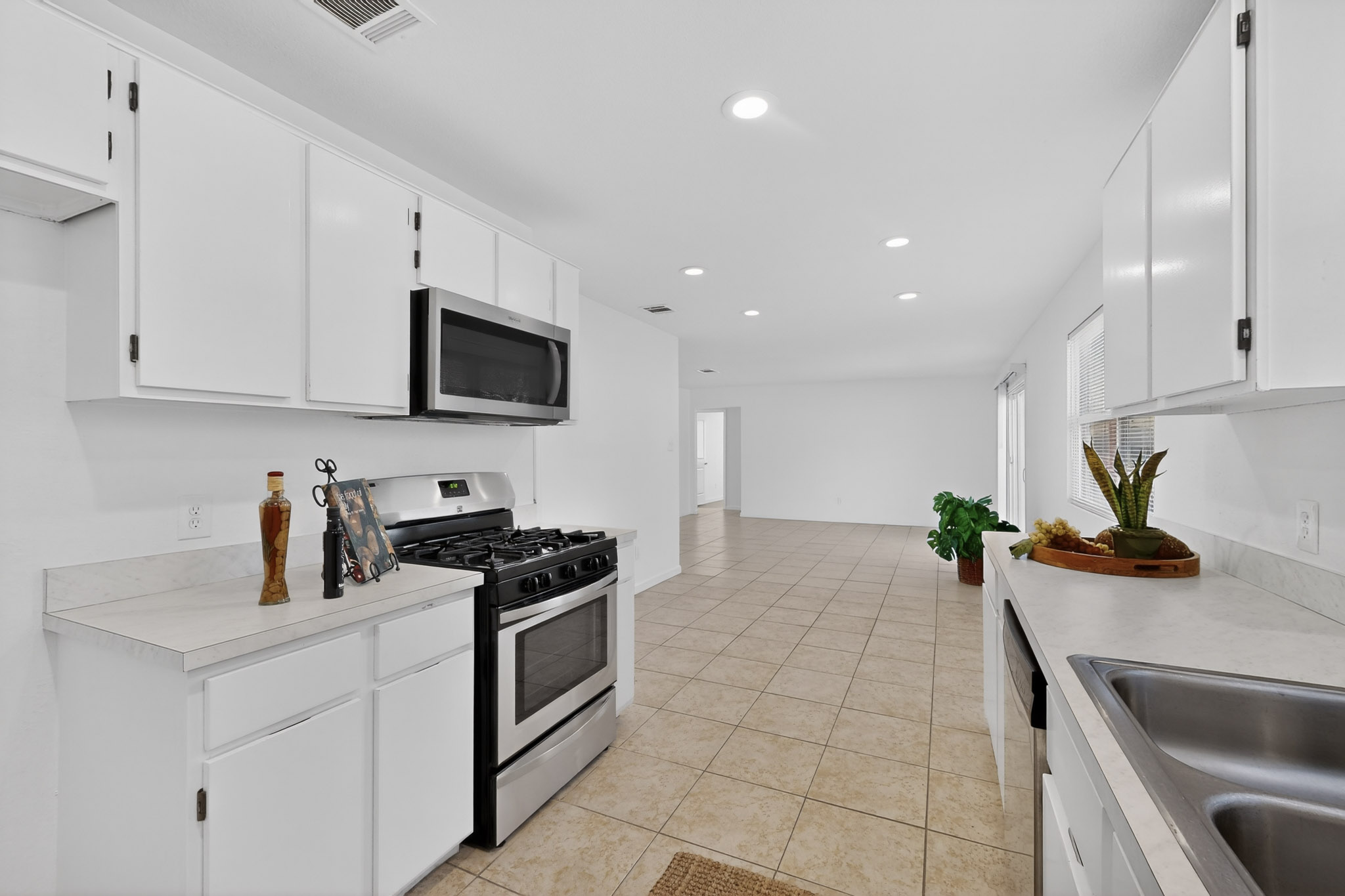 7200 Barnsdale Way Austin, TX 78745 - Photo 11 of 26 a kitchen with a sink a stove and cabinets