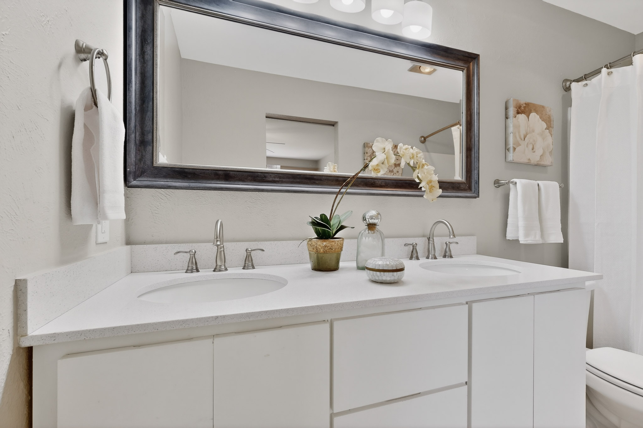 7200 Barnsdale Way Austin, TX 78745 - Photo 16 of 26 a bathroom with double vanity sink and a mirror