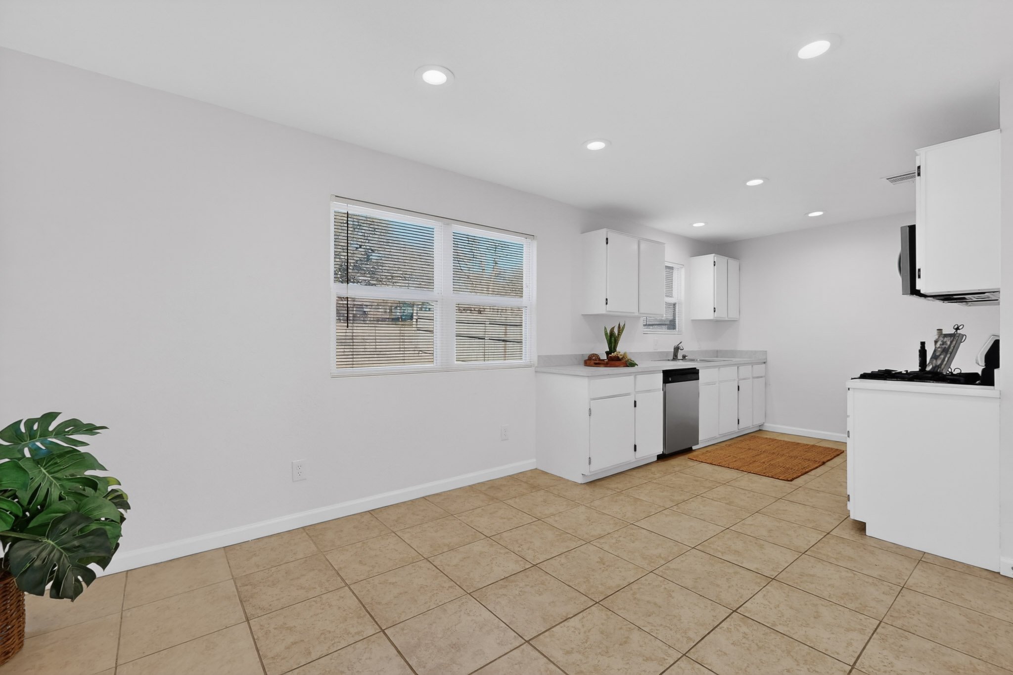 7200 Barnsdale Way Austin, TX 78745 - Photo 8 of 26 a kitchen with granite countertop white cabinets and white appliances