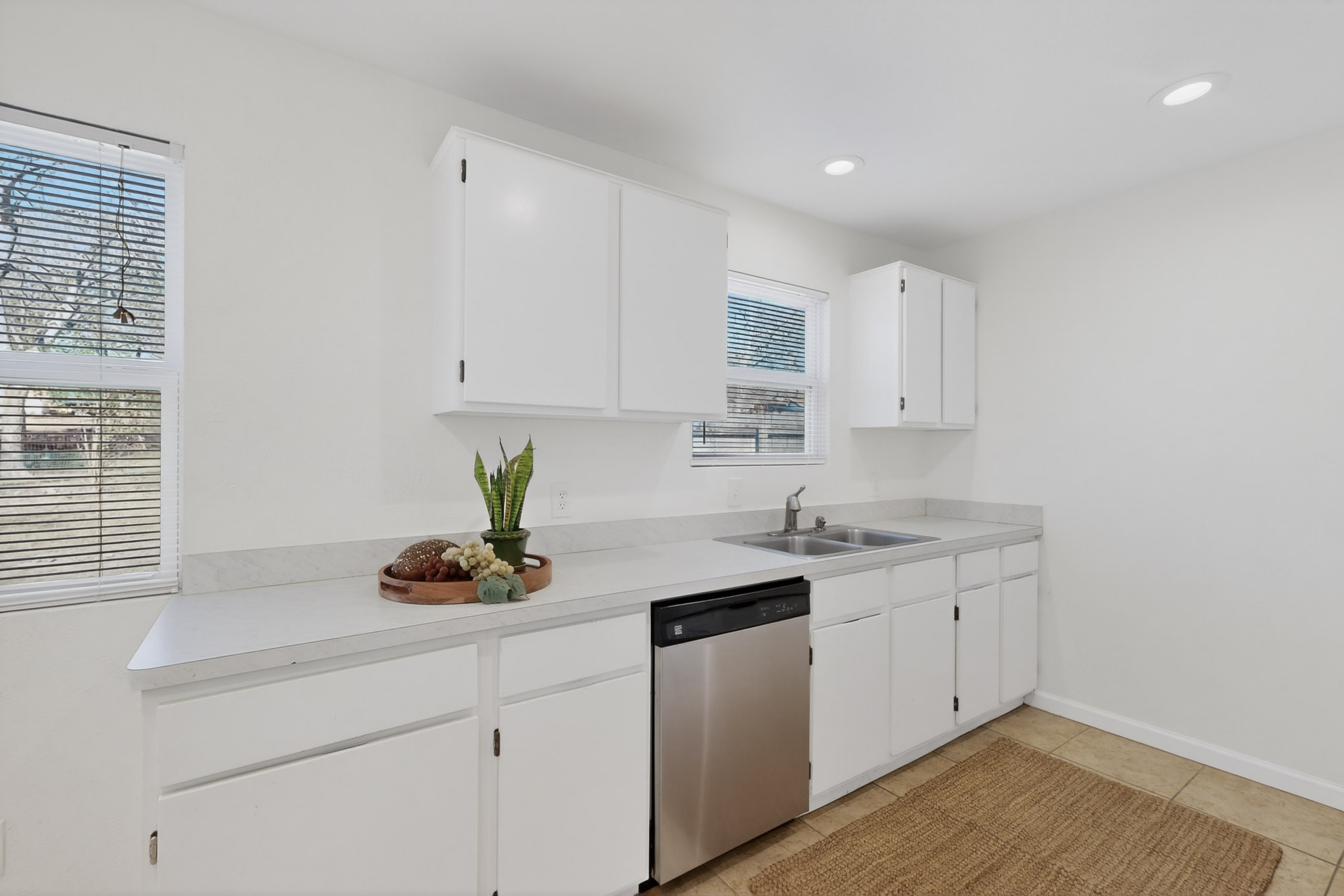 7200 Barnsdale Way Austin, TX 78745 - Photo 9 of 26 a kitchen with a sink cabinets and window