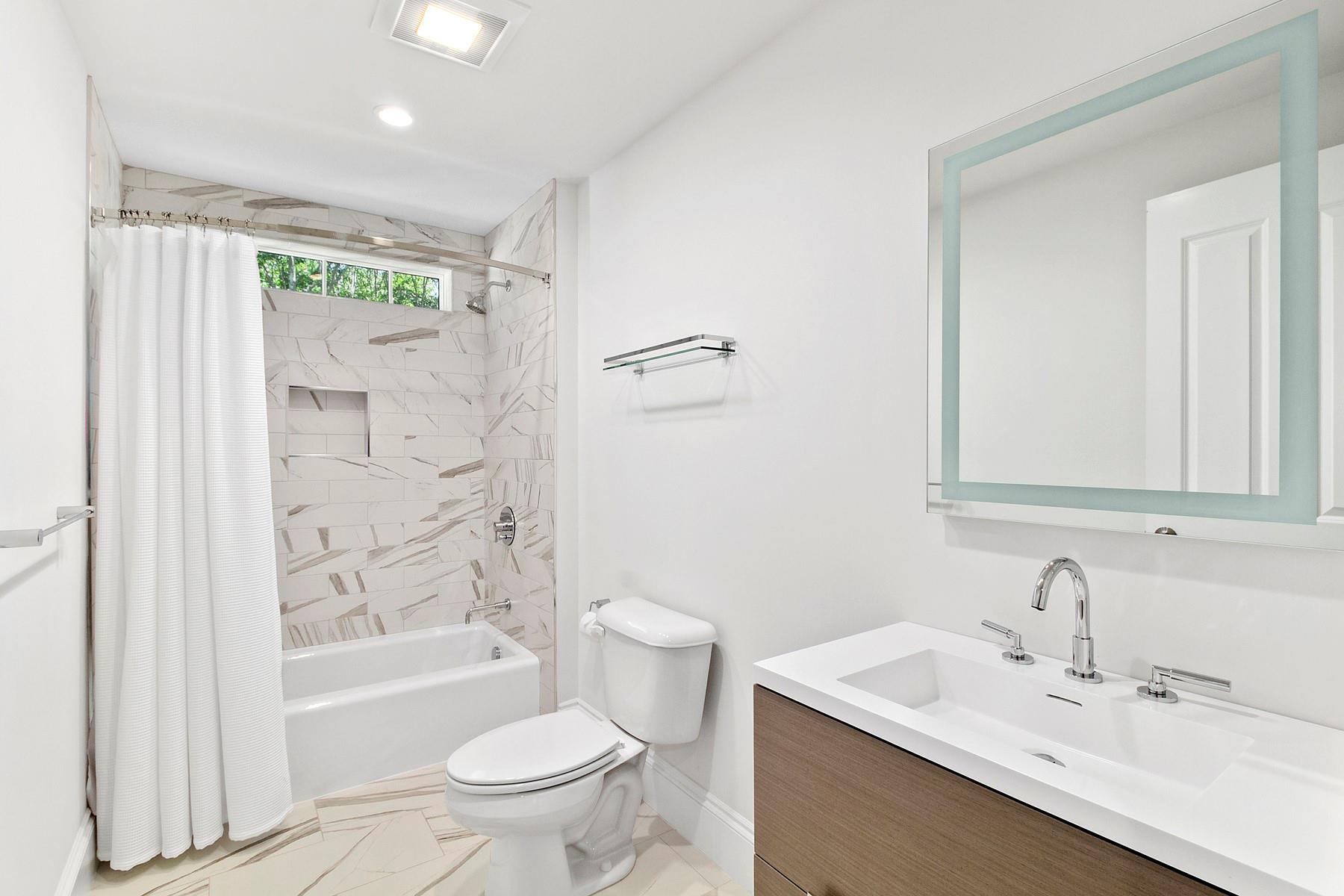 421 Edge Of Woods Road Southampton, NY 11968 - Photo 18 of 33 Bathroom featuring vanity and shower / bath combination with curtain