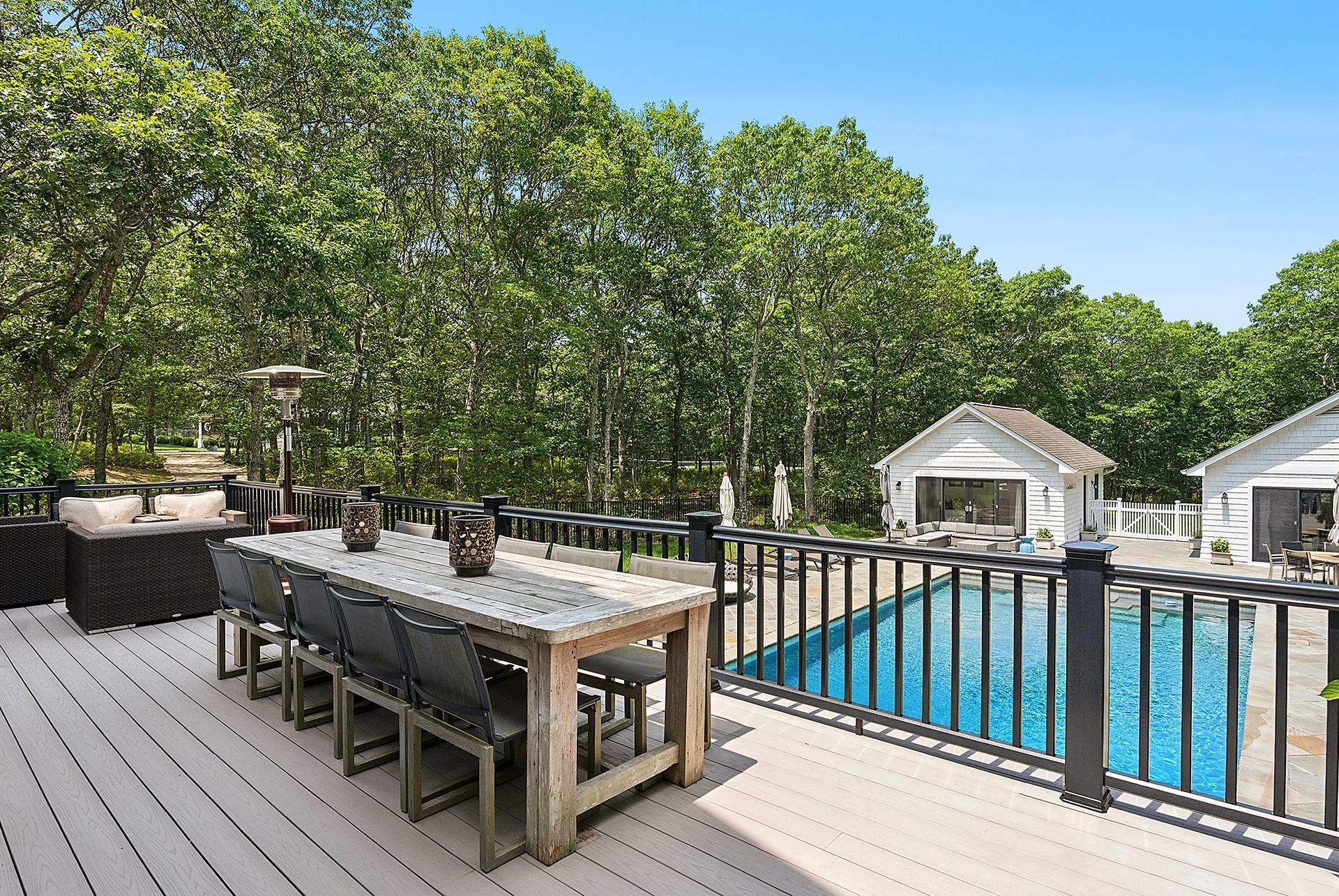 421 Edge Of Woods Road Southampton, NY 11968 - Photo 4 of 33 Wooden deck with an outdoor living space, outdoor dining area, an outbuilding, and a patio