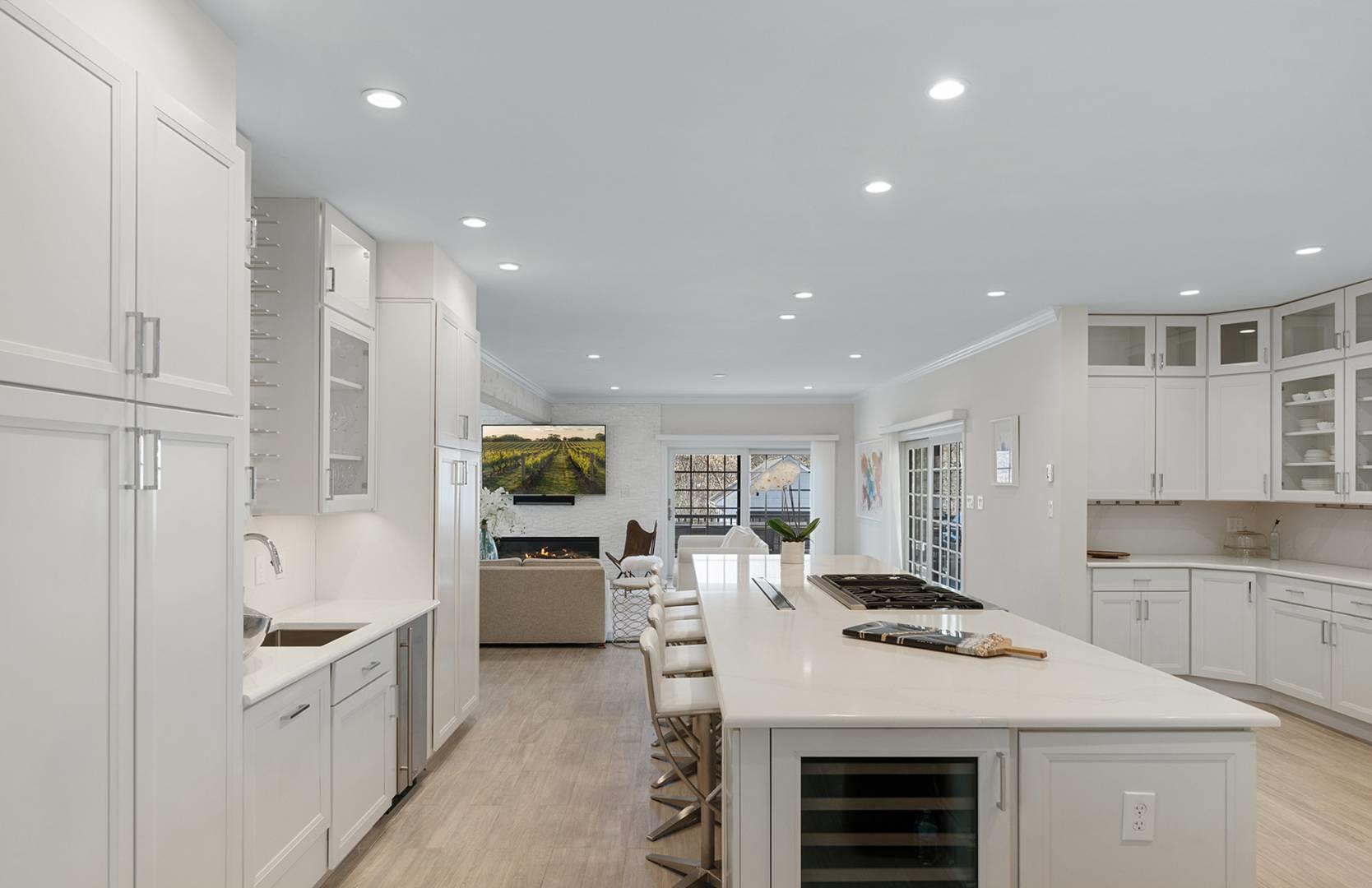 421 Edge Of Woods Road Southampton, NY 11968 - Photo 30 of 33 Kitchen featuring beverage cooler, open floor plan, stainless steel gas cooktop, white cabinets, and light wood finished floors