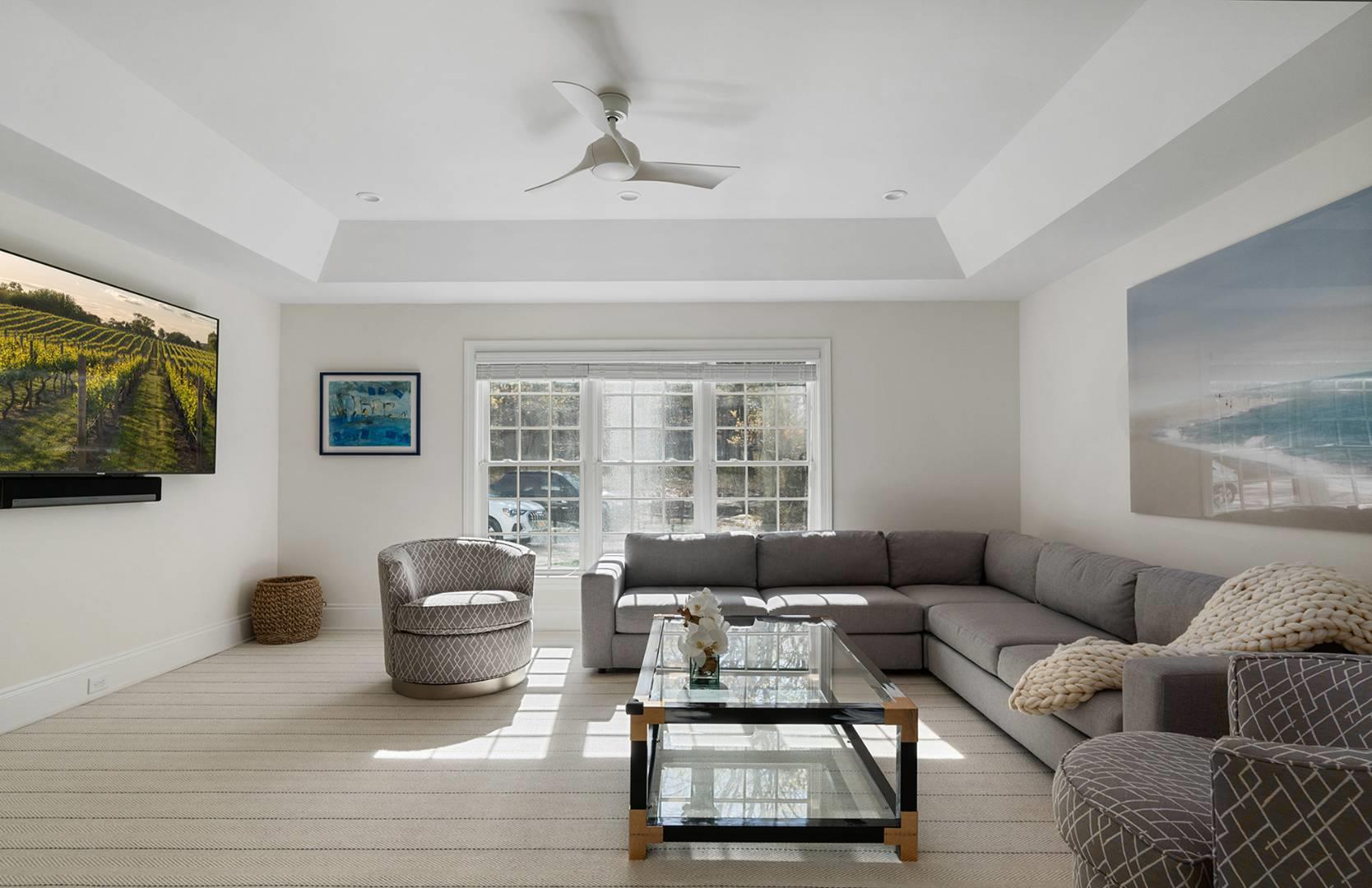 421 Edge Of Woods Road Southampton, NY 11968 - Photo 9 of 33 Living room featuring a tray ceiling and a ceiling fan