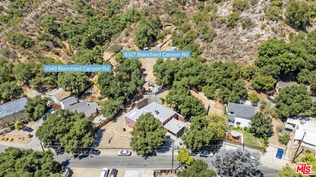 an aerial view of a house with a yard and garden