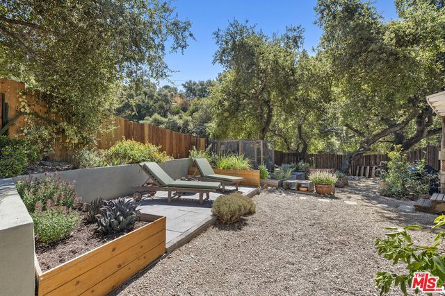 a view of a chairs and table in backyard