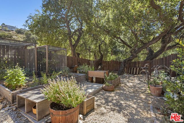 an aerial view of a house with a yard and garden