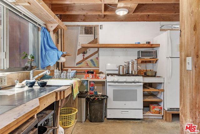a view of a livingroom with furniture and a window
