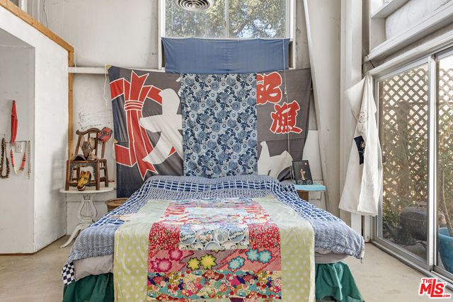 a view of a backyard with potted plants and a large tree