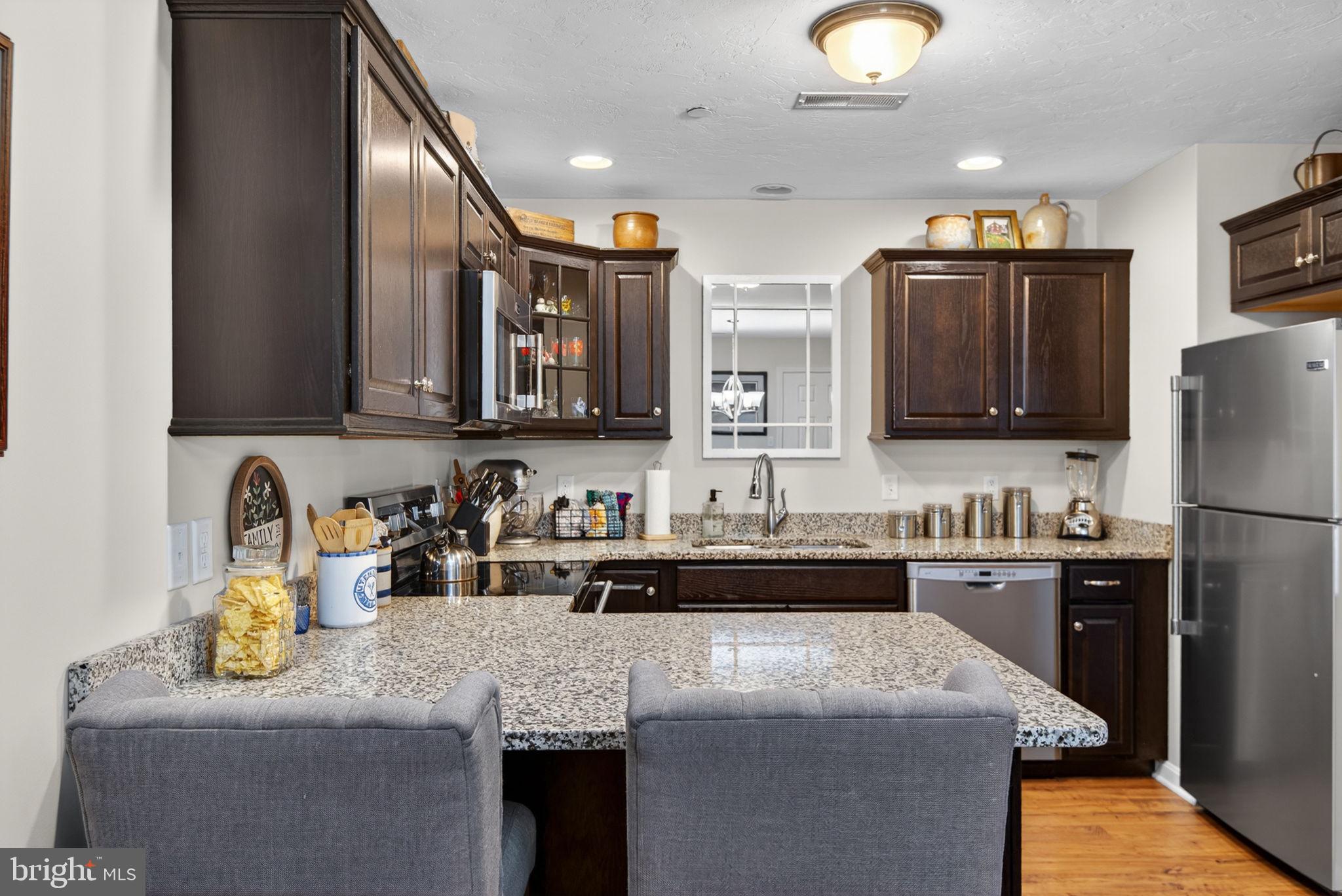 1332 Pleasant View Drive, Unit 75 Spring Grove, PA 17362 - Photo 13 of 26 a kitchen with stainless steel appliances granite countertop a sink stove and refrigerator