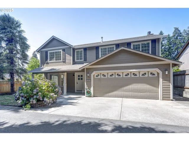 a view of a house with a yard and potted plants