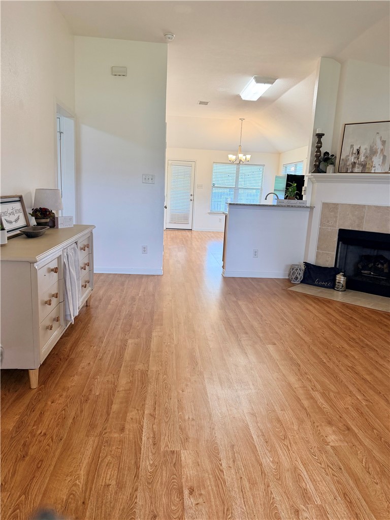 1029 Fallbrook Loop College Station, TX 77845 - Photo 4 of 34 a view of a kitchen with kitchen island a sink wooden floor and a living room view