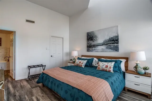 a bedroom with bed and wall painting