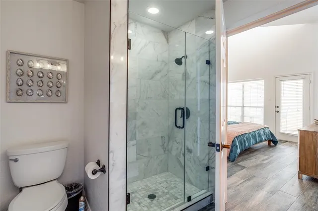 a bathroom with a toilet and a shower