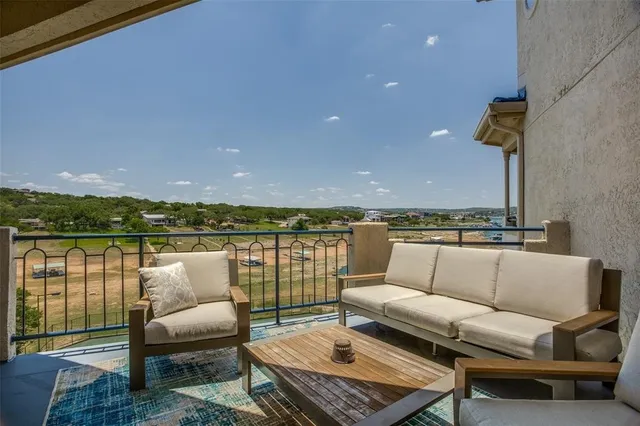 wooden roof deck with couches and potted plants