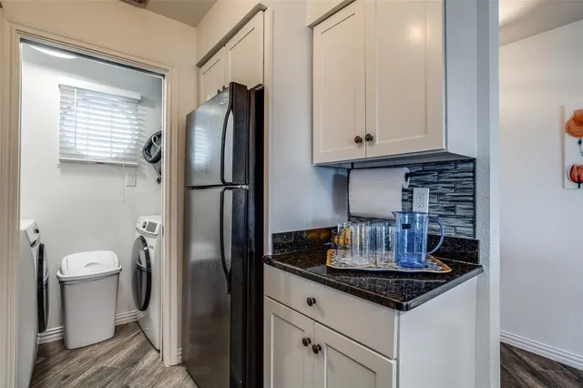 a kitchen with stainless steel appliances granite countertop a refrigerator and a sink