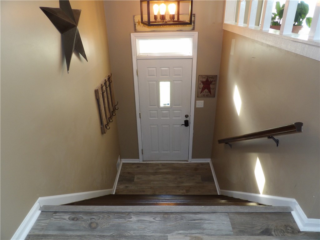 4505 North Alcony Conover Road Conover, OH 45317 - Photo 39 of 64 This inviting entryway features natural light and durable flooring, offering a warm welcome.