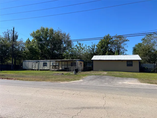 a backyard of a house with lots of green space and plants