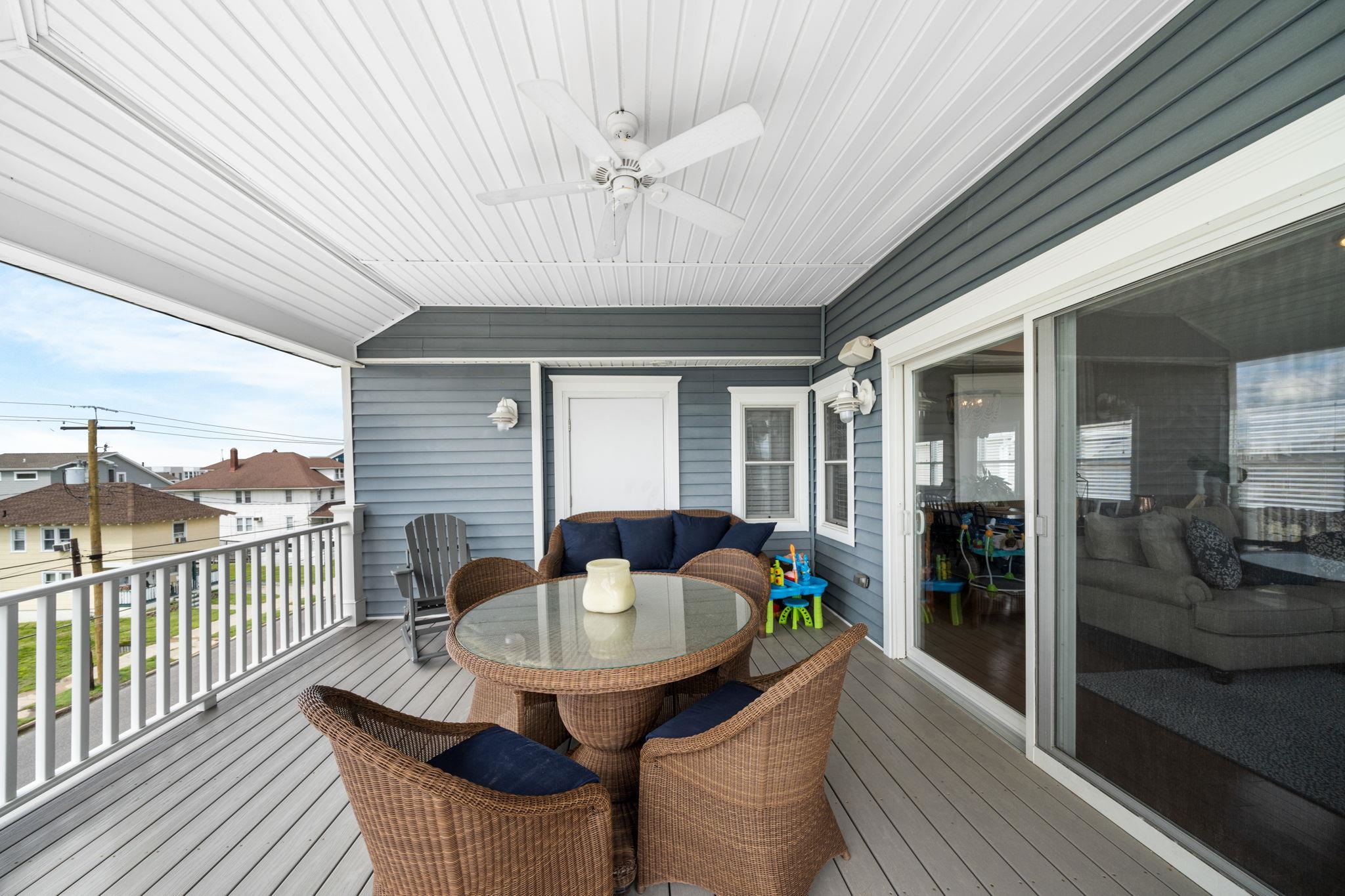 147 43rd Street Sea Isle City, NJ 08243 - Photo 17 of 50 a dining room with furniture a chandelier and wooden floor