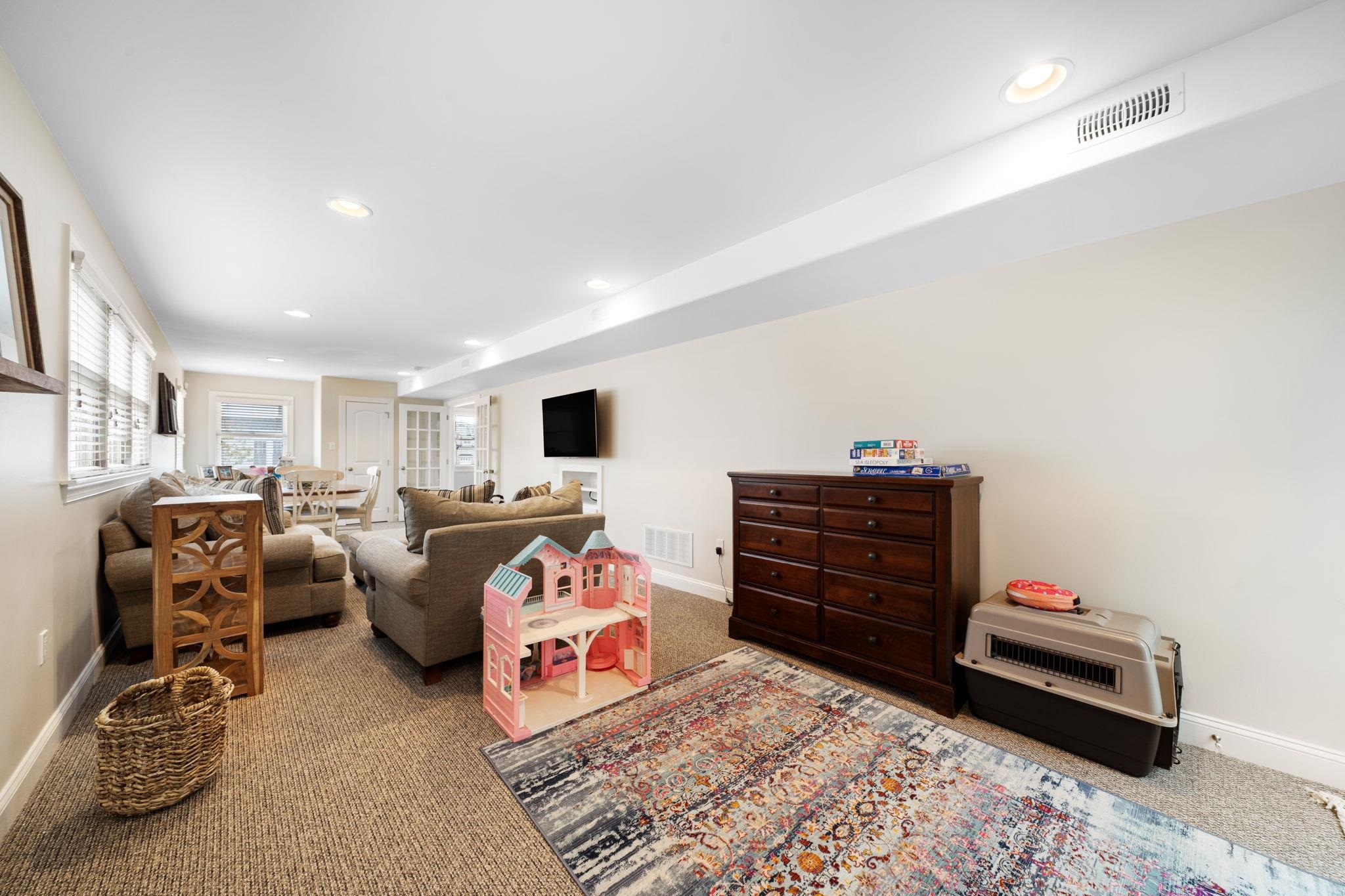 147 43rd Street Sea Isle City, NJ 08243 - Photo 19 of 50 a bed room with furniture and a flat screen tv