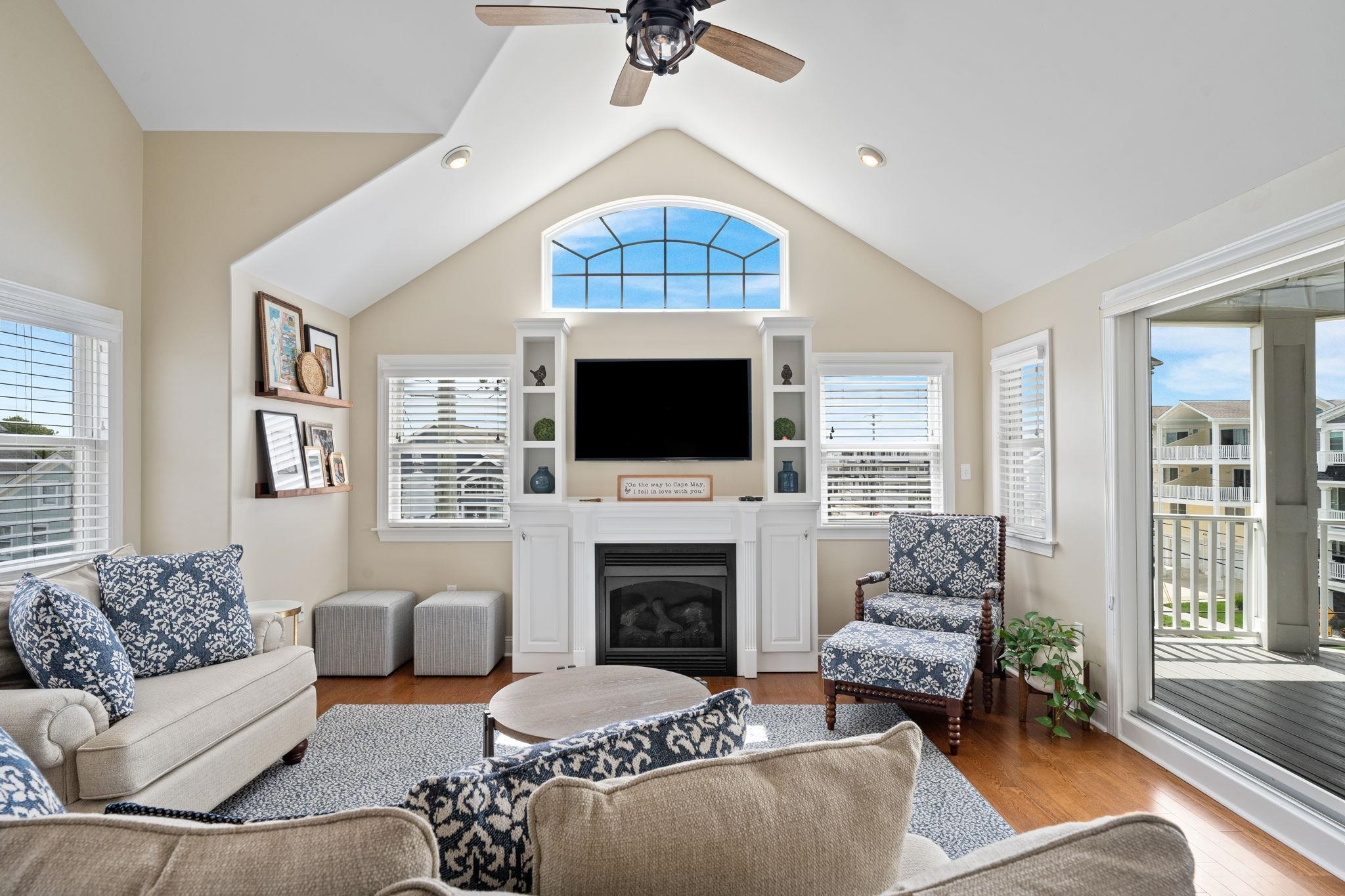 147 43rd Street Sea Isle City, NJ 08243 - Photo 2 of 50 a living room with furniture a fireplace and a flat screen tv