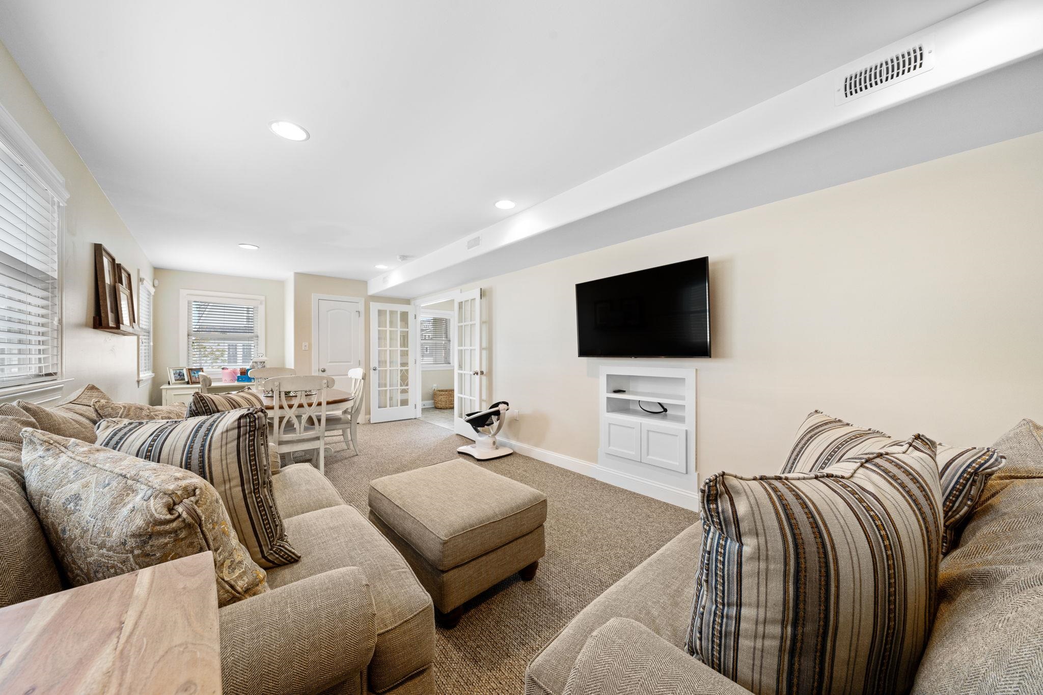 147 43rd Street Sea Isle City, NJ 08243 - Photo 22 of 50 a living room with furniture and a flat screen tv