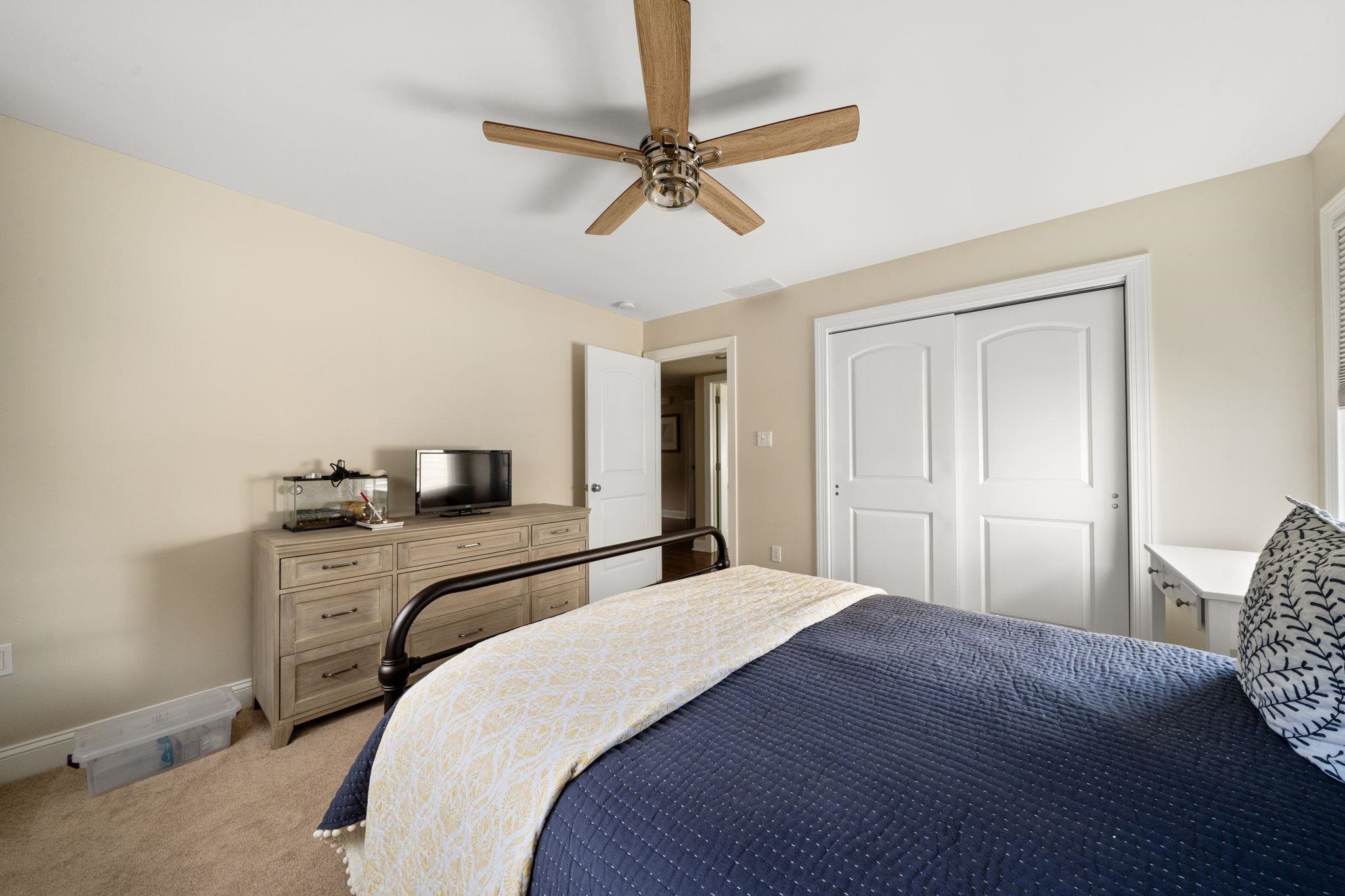 147 43rd Street Sea Isle City, NJ 08243 - Photo 23 of 50 a bedroom with a bed and a chandelier