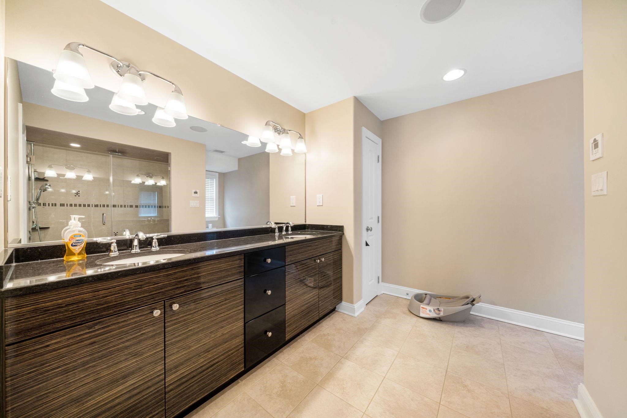 147 43rd Street Sea Isle City, NJ 08243 - Photo 27 of 50 a bathroom with a sink mirror and vanity
