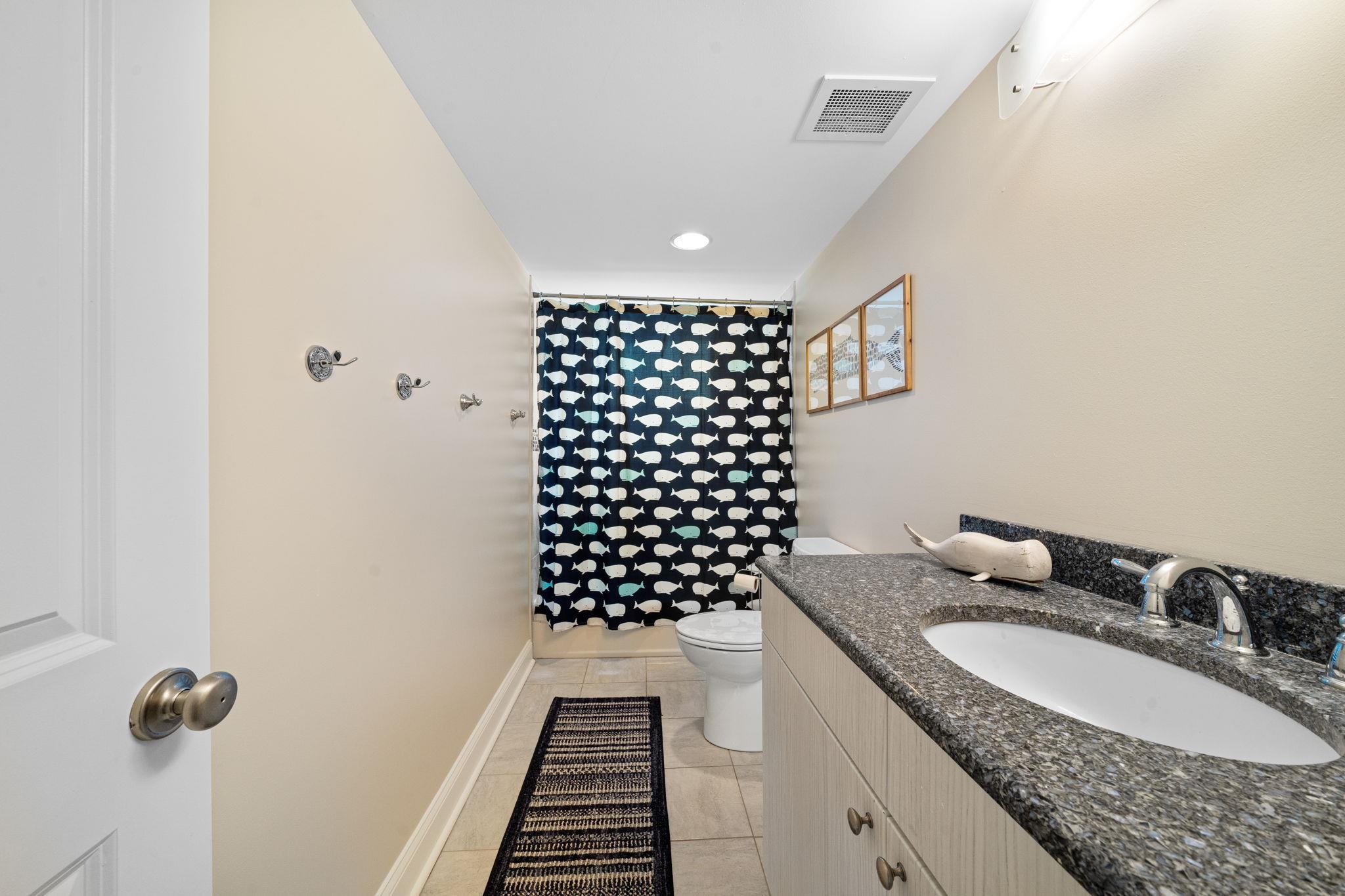 147 43rd Street Sea Isle City, NJ 08243 - Photo 29 of 50 a bathroom with a granite countertop sink and a mirror
