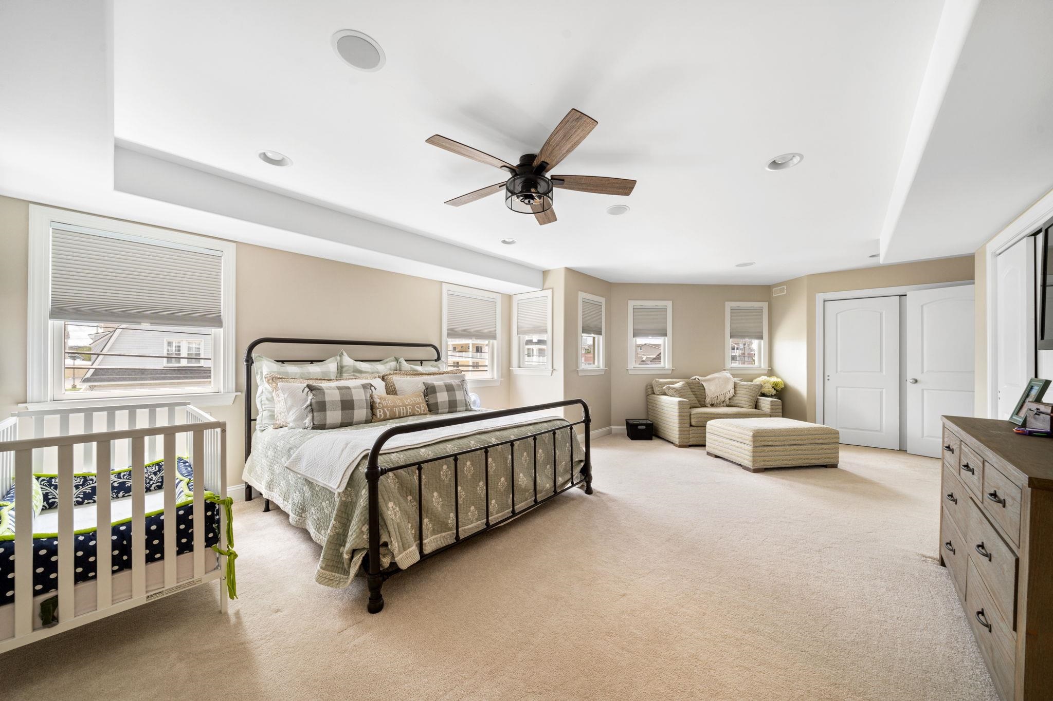 147 43rd Street Sea Isle City, NJ 08243 - Photo 37 of 50 a spacious bedroom with a bed couch and a window