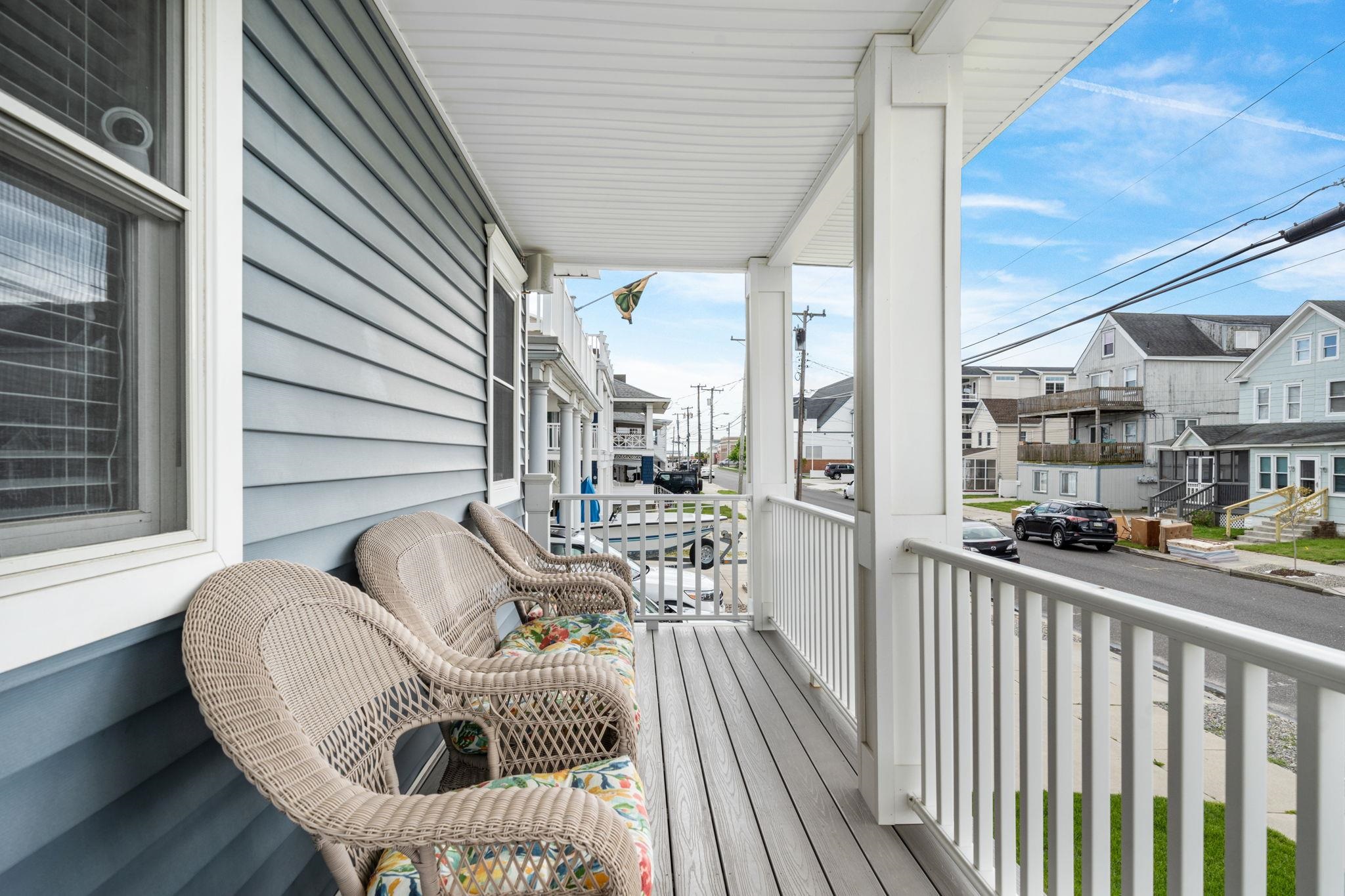 147 43rd Street Sea Isle City, NJ 08243 - Photo 47 of 50 a balcony with wooden floor table and chairs