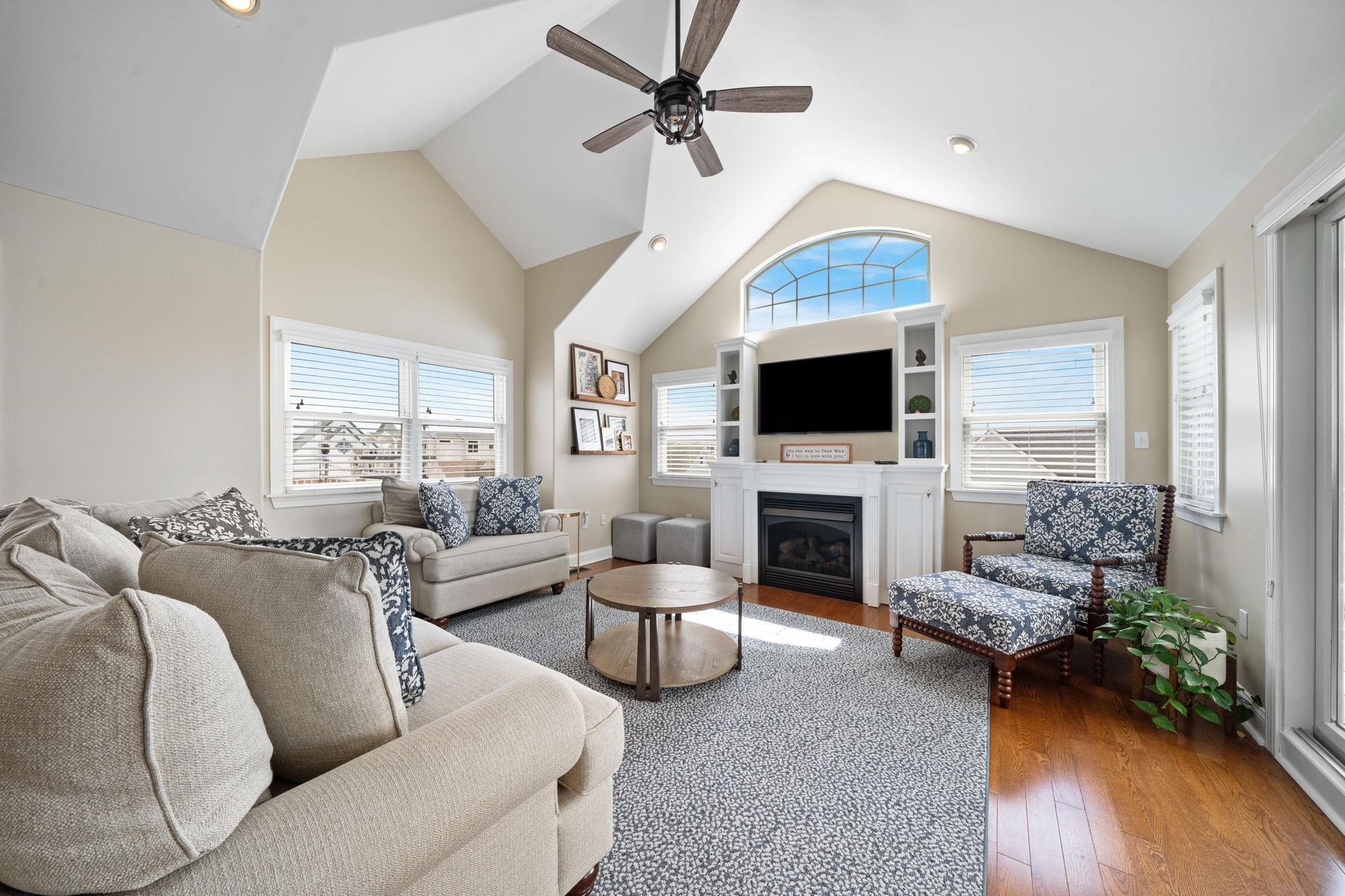 147 43rd Street Sea Isle City, NJ 08243 - Photo 8 of 50 a living room with furniture a fireplace and a flat screen tv