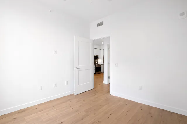 a bathroom with a granite countertop sink a toilet and a mirror