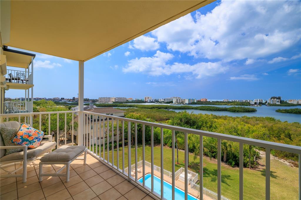 9000 Commodore Drive, Unit 604 Seminole, FL 33776 - Photo 1 of 50 a view of a balcony with two chairs