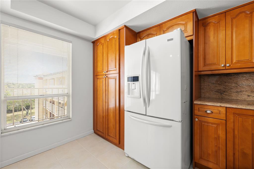 9000 Commodore Drive, Unit 604 Seminole, FL 33776 - Photo 14 of 50 a white refrigerator freezer sitting in a kitchen